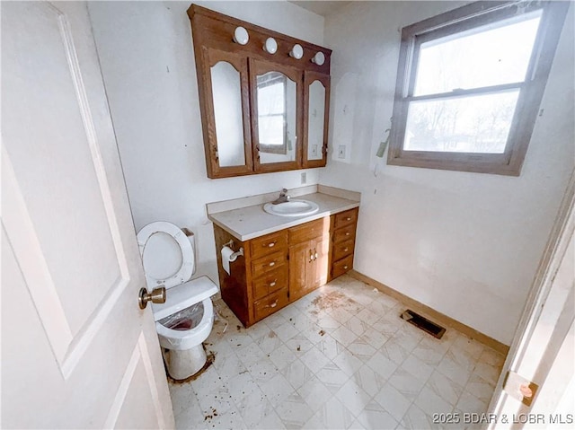 bathroom with toilet and vanity