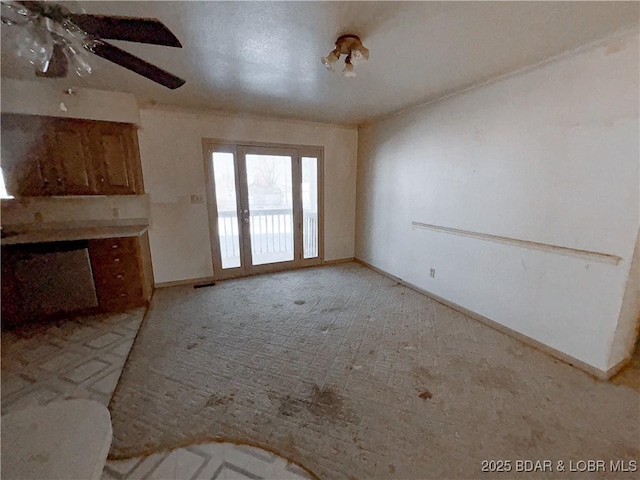 unfurnished living room featuring ceiling fan