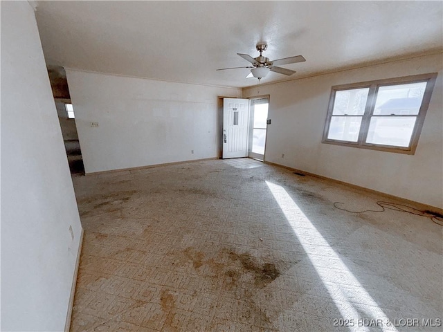 unfurnished room featuring ceiling fan and light colored carpet