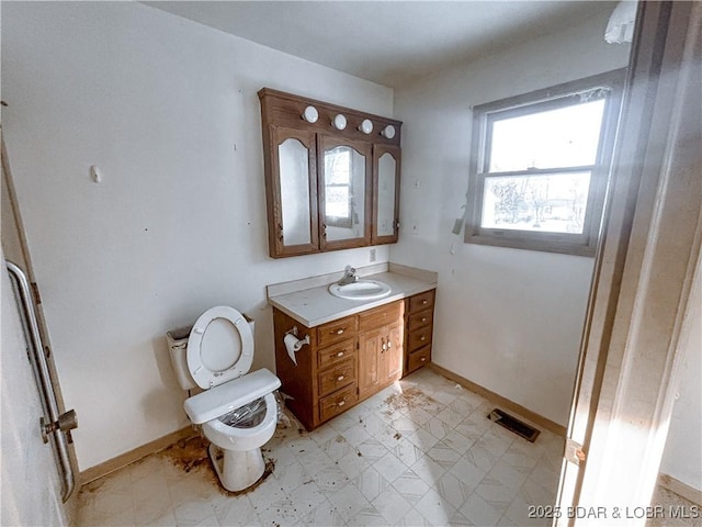 bathroom featuring toilet and vanity