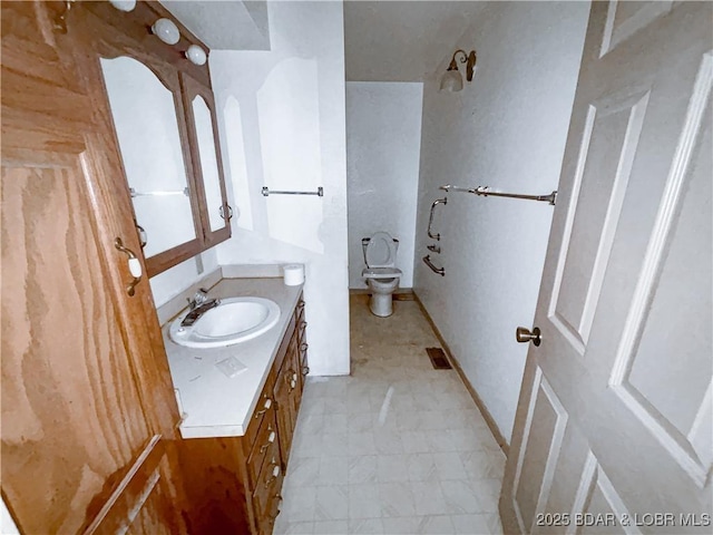 bathroom with toilet and vanity