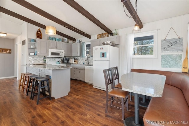 kitchen featuring pendant lighting, white appliances, a center island, vaulted ceiling with beams, and gray cabinetry