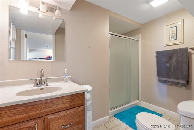 bathroom featuring a shower with shower door, vanity, tile patterned flooring, and toilet