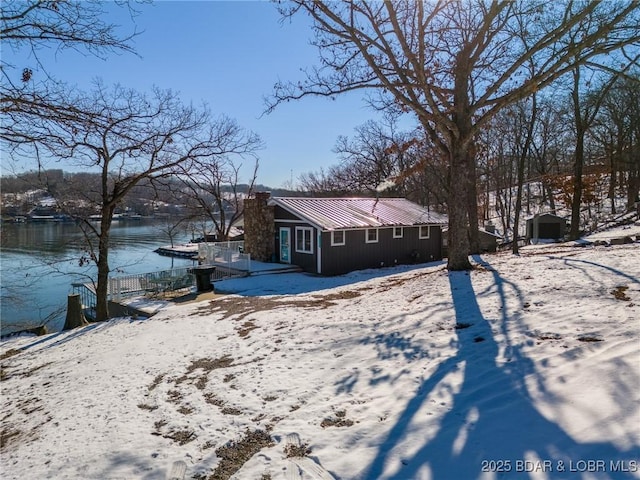 view of snow covered exterior with a water view