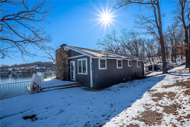 view of snow covered exterior with a water view