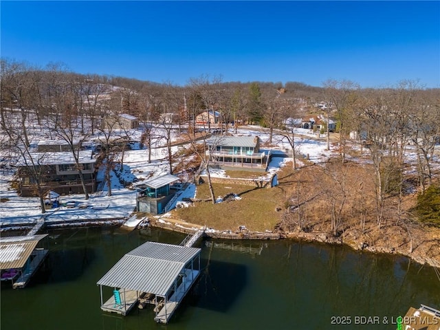 snowy aerial view featuring a water view