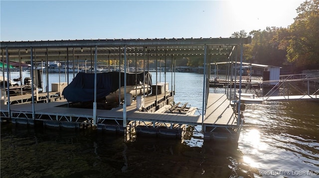 dock area with a water view and boat lift