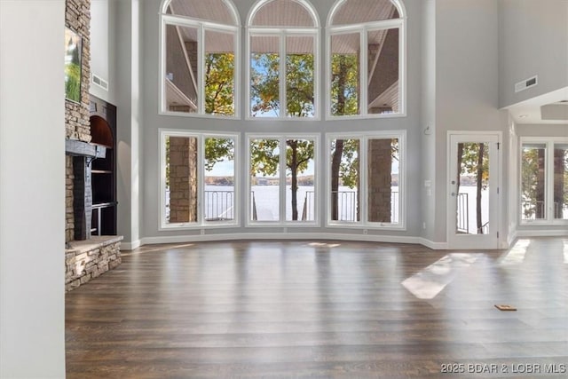 interior space with plenty of natural light and a stone fireplace