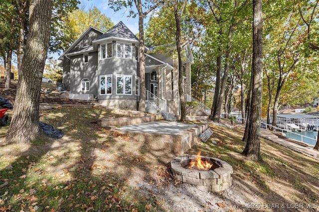 back of house featuring a fire pit