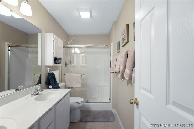 bathroom with toilet, a shower with door, vanity, and tile patterned flooring