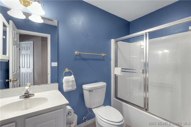 full bathroom with toilet, bath / shower combo with glass door, and vanity