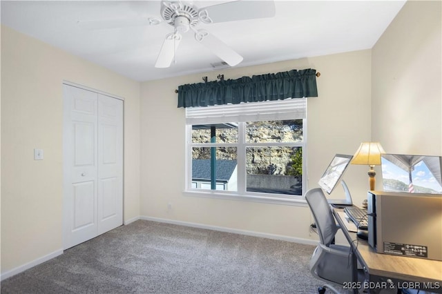 home office with carpet, a ceiling fan, and baseboards