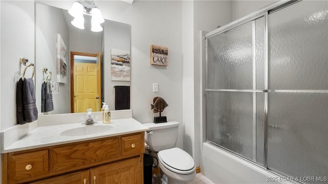 full bathroom featuring bath / shower combo with glass door, toilet, and vanity