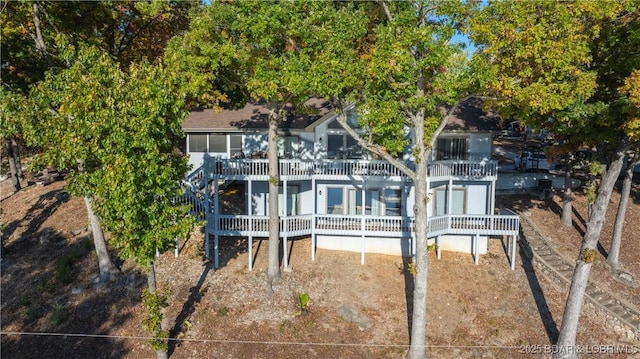 rear view of house featuring a wooden deck