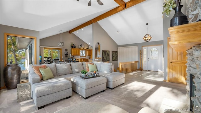 carpeted living room with high vaulted ceiling and beamed ceiling