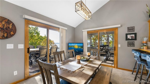 dining space with plenty of natural light, light carpet, and lofted ceiling