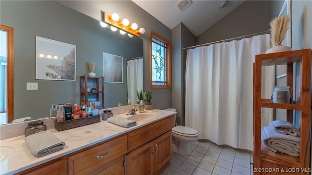 bathroom featuring lofted ceiling, vanity, tile patterned flooring, and toilet