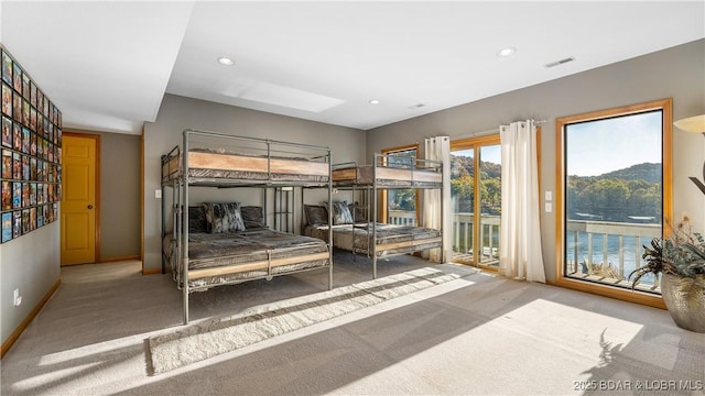 carpeted bedroom featuring access to exterior and a mountain view