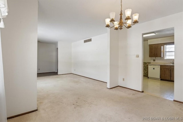 empty room with sink and an inviting chandelier