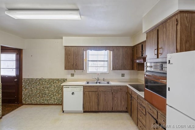 kitchen featuring sink and white appliances