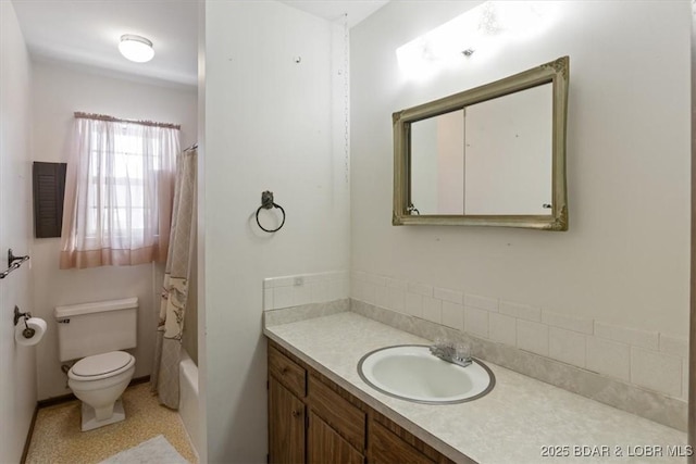 full bathroom featuring toilet, vanity, and shower / bath combo with shower curtain