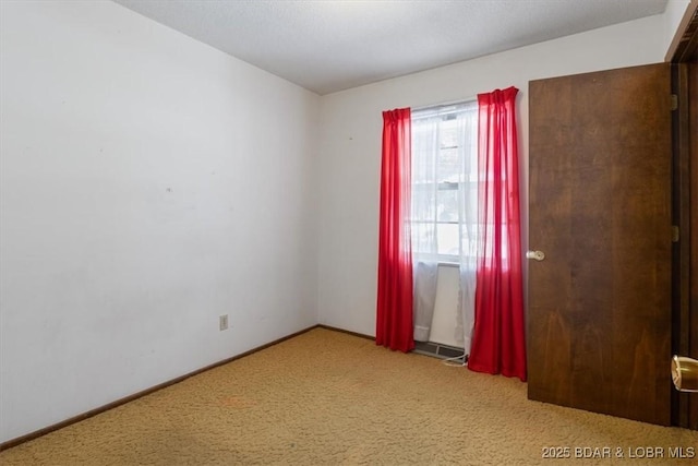 unfurnished room with light colored carpet