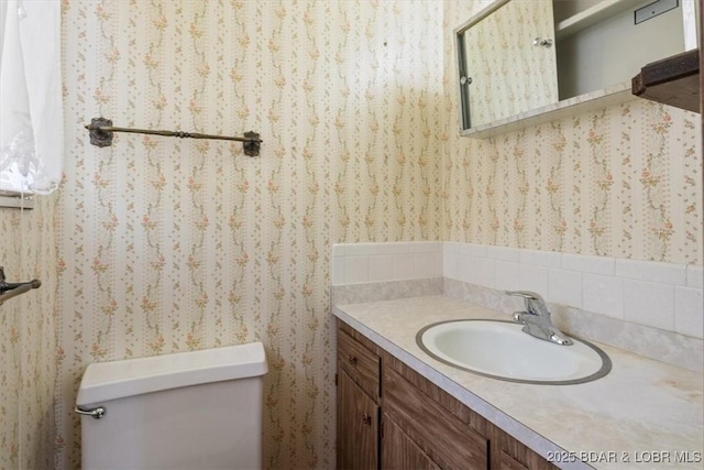 bathroom featuring toilet and vanity