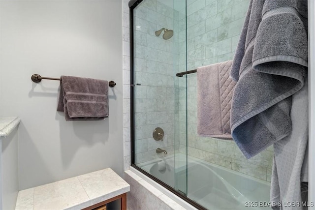 bathroom with shower / bath combination with glass door