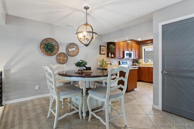 dining room with light tile patterned flooring and a chandelier