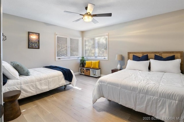 bedroom with ceiling fan and light wood-type flooring