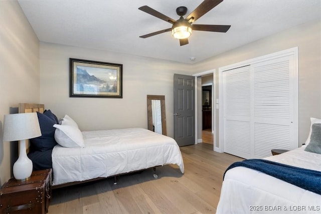 bedroom featuring light hardwood / wood-style flooring, a closet, and ceiling fan