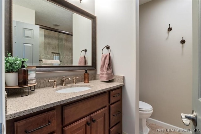 bathroom with vanity, tile patterned flooring, a shower with door, and toilet