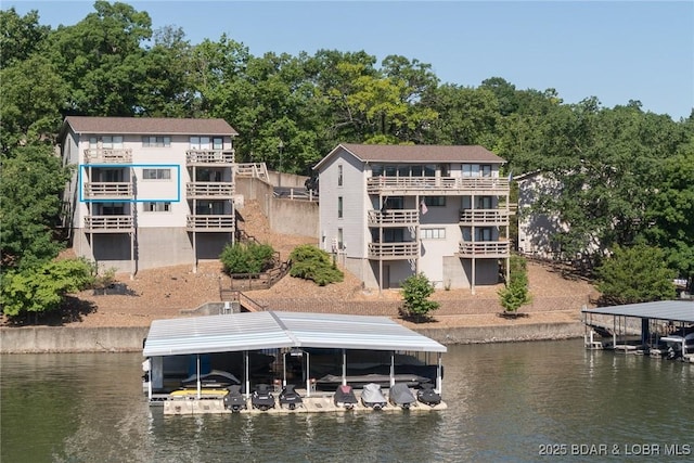 16 Hawk Harbor Ln Unit 2B, Lake Ozark, MO 65049 - dock with boat lift and a water view