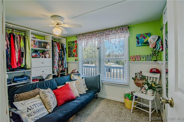 interior space featuring ceiling fan and carpet flooring