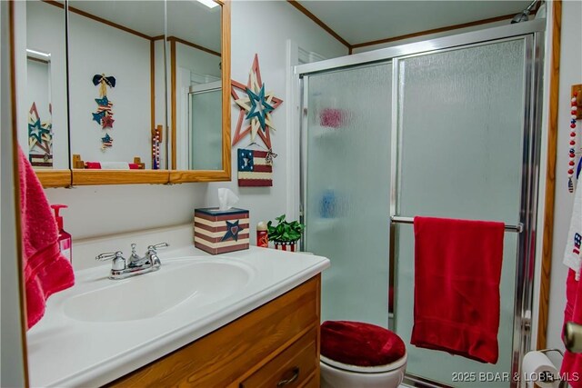 bathroom featuring an enclosed shower, vanity, and toilet