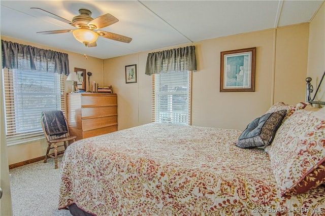 bedroom featuring ceiling fan, carpet flooring, and multiple windows