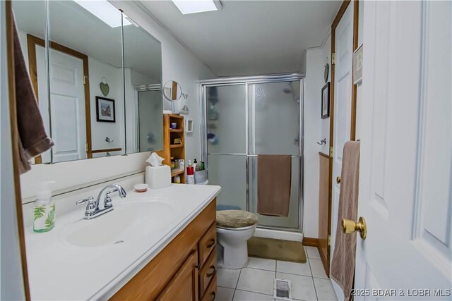 bathroom with an enclosed shower, vanity, tile patterned floors, and toilet