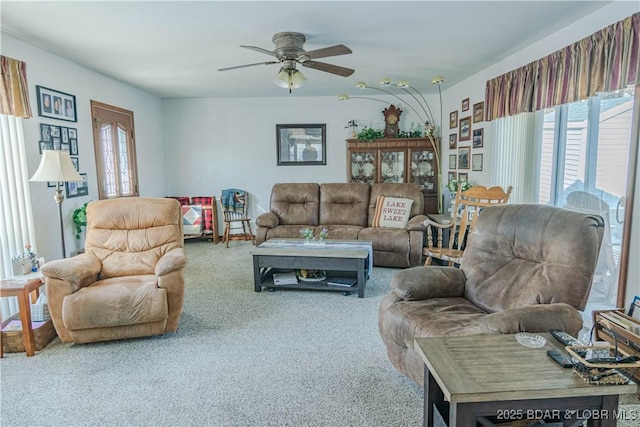 carpeted living room featuring ceiling fan