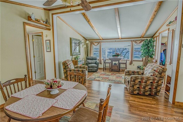 dining space with lofted ceiling, ceiling fan, and light hardwood / wood-style floors