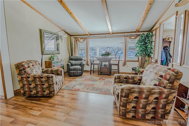 interior space with lofted ceiling with beams and light hardwood / wood-style floors