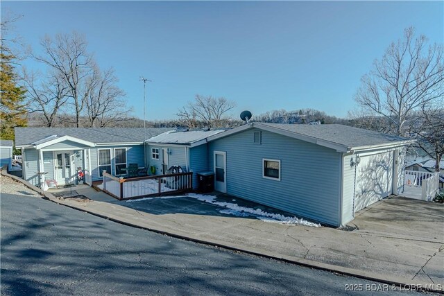 view of front facade featuring a deck and a garage