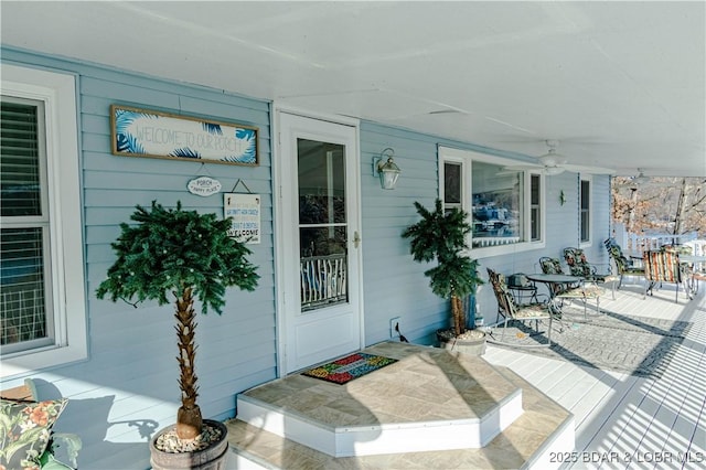 doorway to property featuring ceiling fan