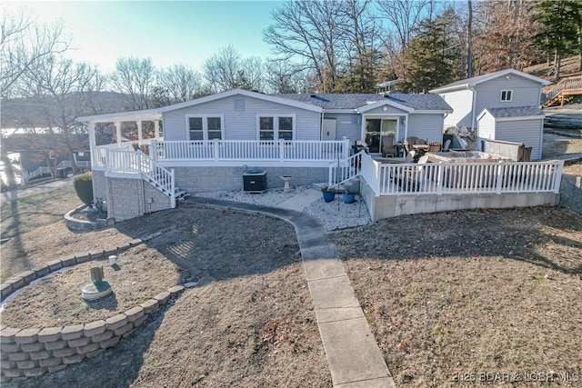 back of property featuring a wooden deck