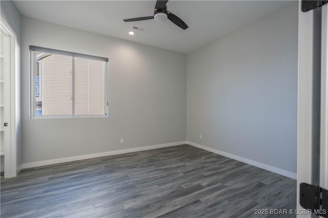 spare room featuring ceiling fan and dark hardwood / wood-style flooring