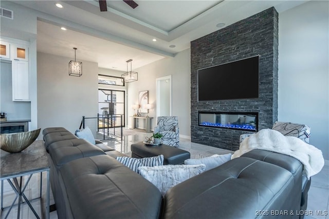 living room with ceiling fan and a fireplace