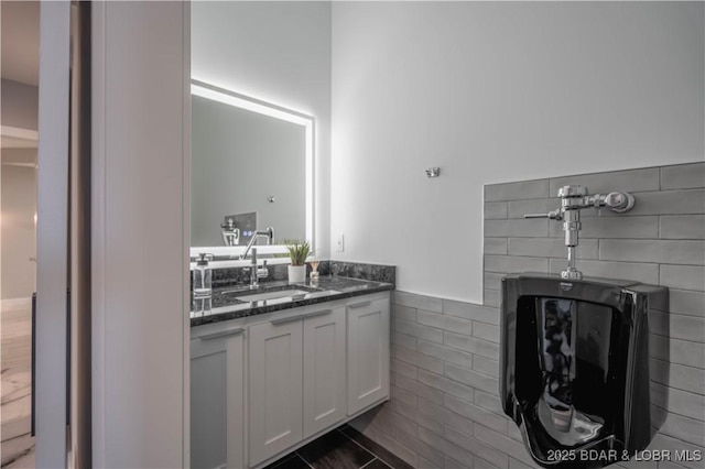 bathroom with tile patterned flooring, tile walls, and vanity