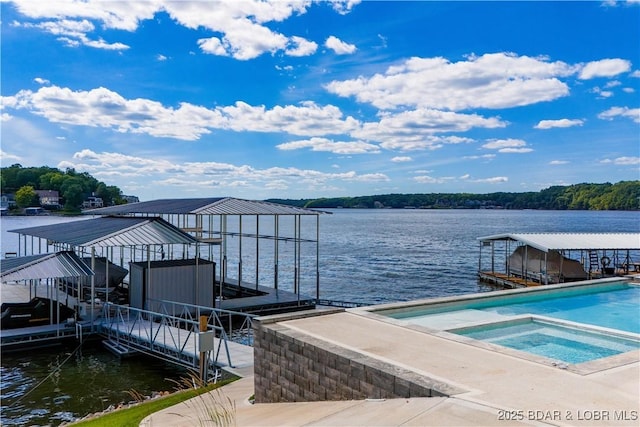 dock area with a swimming pool with hot tub and a water view