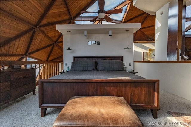 unfurnished bedroom featuring light carpet, a skylight, high vaulted ceiling, and ceiling fan