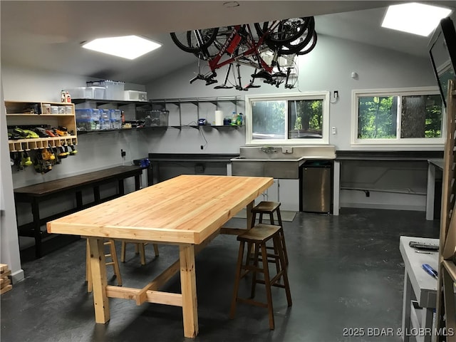 kitchen with refrigerator and vaulted ceiling