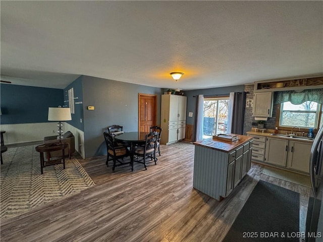 23731 Grant Rd, Barnett, MO 65011 - kitchen with dark wood-style flooring, healthy amount of natural light, a center island, a textured ceiling, and gray cabinetry